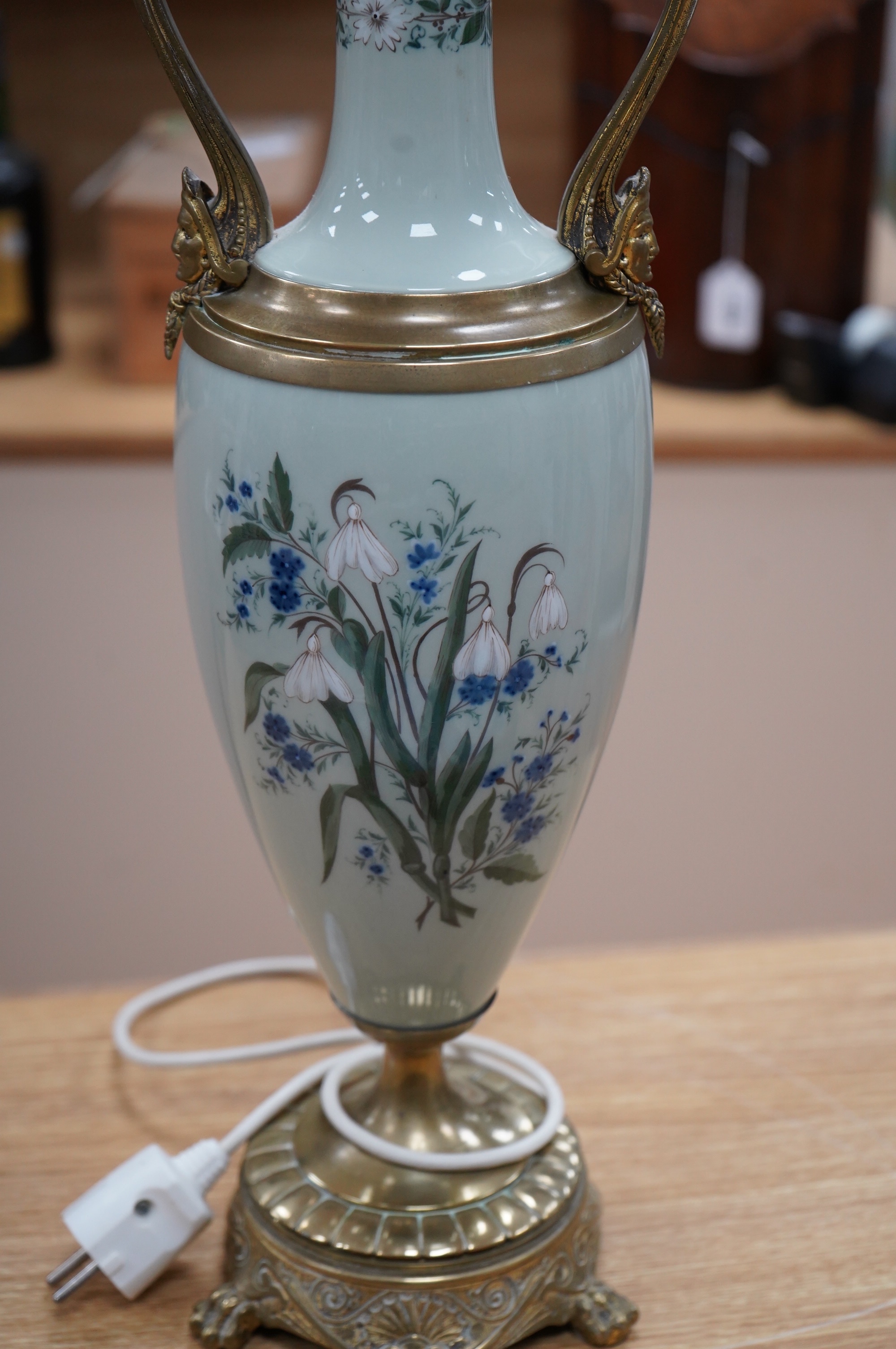 A late 19th century French celadon green glazed lamp, painted with flowers, fitted as a lamp, 56cm high overall. Condition - good